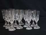 six crystal wine glasses are lined up on a black surface