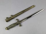 pair of antique bronzed swords on a white background