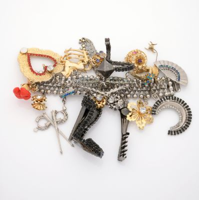 a lot of brooches that are laying on a white surface