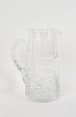 a clear glass pitcher with a handle sitting on a white surface