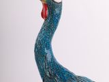 a blue bird with a red beak on a white background
