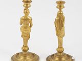 pair of antique brass candlesticks with figures on bases