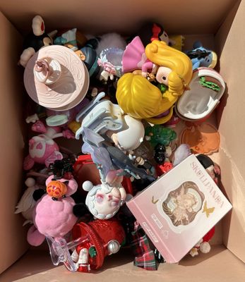 a cardboard box filled with a bunch of small toys
