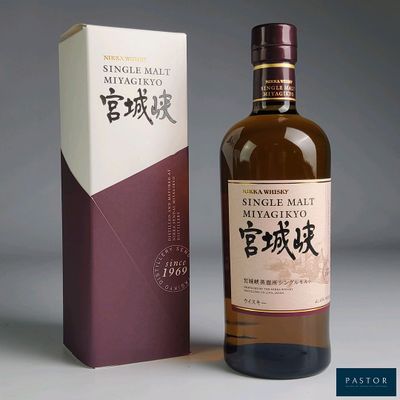a bottle of single mal japanese whisky next to a box