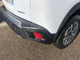a close up of a white car parked in a parking lot
