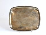 a silver tray with a silver handle on a white surface