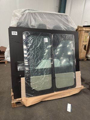 two windows that are wrapped in plastic in a warehouse