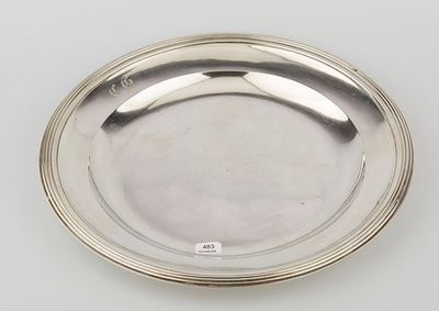 a silver plate on a white surface with a silver rim