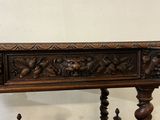 a wooden table with carvings on the top of it