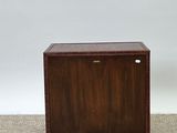 a small wooden cabinet with a drawer on top of it