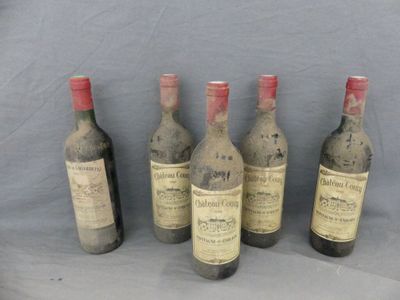 six bottles of wine are lined up on a table