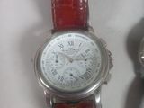 a watch that is sitting on a table next to a watch
