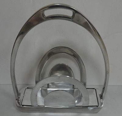 a silver plate and a silver plate holder on a white table