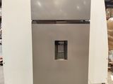 an image of a stainless steel refrigerator in a warehouse