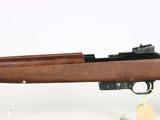 the rifle is on a stand with a tag attached to it