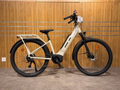 an image of a white electric bike parked in front of a wooden wall