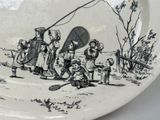 a black and white plate with a picture of a group of children