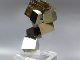 a sculpture made of metal cubes sitting on top of a glass block