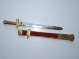pair of antique brass - plated swords with red leather sheaths