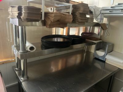 stainless steel counter top in a commercial kitchen with pots and pans on it