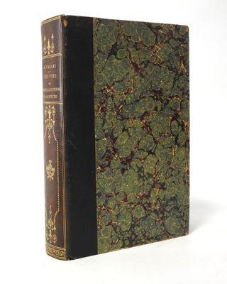 an old book sitting on top of a white table next to a white wall
