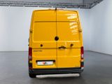 yellow van parked in a large room with white walls