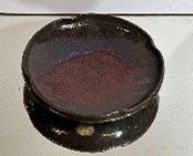 a black bowl sitting on top of a white counter