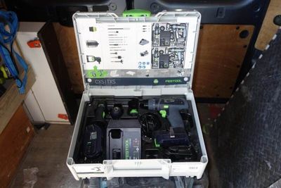 a tool box with tools inside of it on the floor