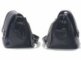 two black purses with chain handles sitting on a white surface