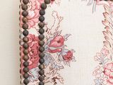 a close up of a chair with beads on it