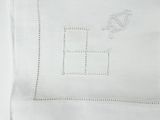 a close up of a white towel with a kite on it