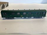 a green train car that is sitting on a table