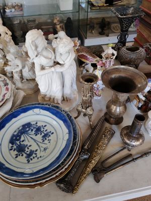 a table that has a lot of antique items on it