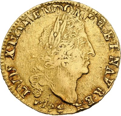 a gold coin with a woman ' s head and a crown on it