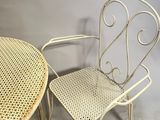 two chairs and a table in a room with a gray wall