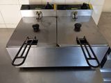 two deep fryers that are sitting on a counter