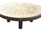 a round table with a mosaic top on a white background