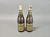two bottles of wine sitting next to each other on a table