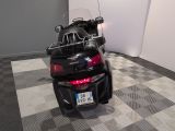 a black motorcycle parked in a room with a checkered floor
