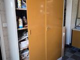 a cabinet with a door that is open in a room