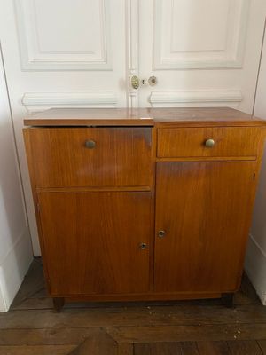 a wooden cabinet with two drawers in the corner of a room