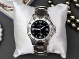 a watch sitting on a pillow on a table