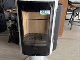a black and white stove sitting on a pedestal in a room