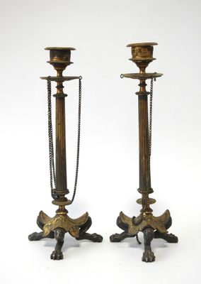 pair of antique brass candlesticks with chain handles