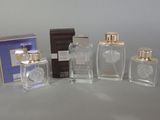 three bottles of perfume sitting next to each other on a table