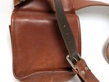 brown leather camera case with strap on a white background