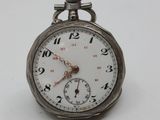 a silver pocket watch on a white surface