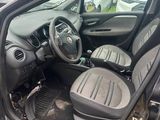 the interior of a car with the door open and the driver ' s seat down