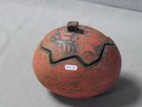a small orange ball with writing on it on a table
