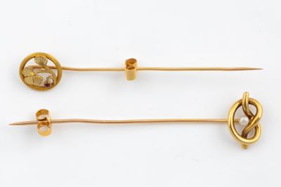 two gold - plated hair pins with a knot and a pearl